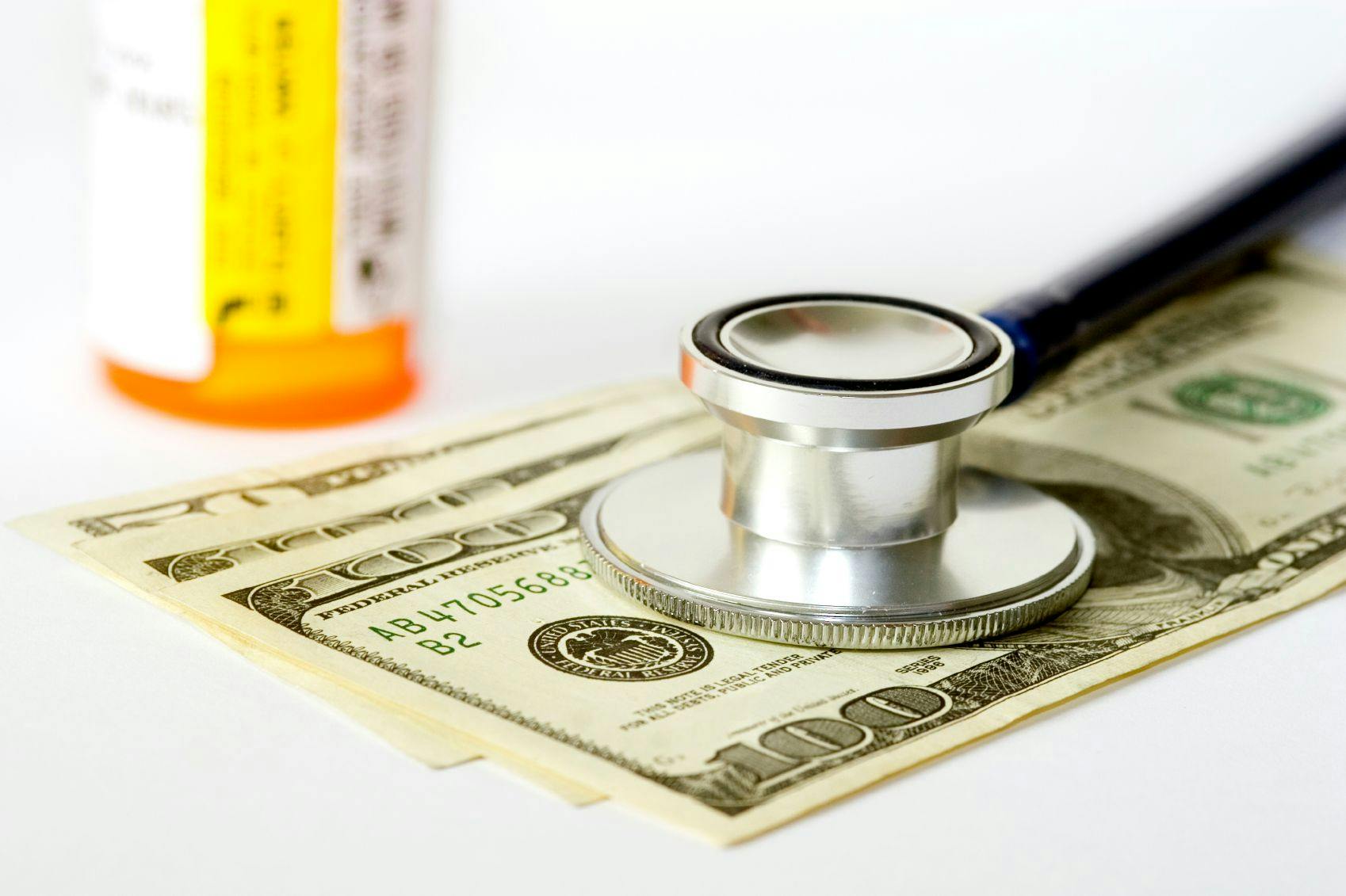 money with stethoscope and medicine